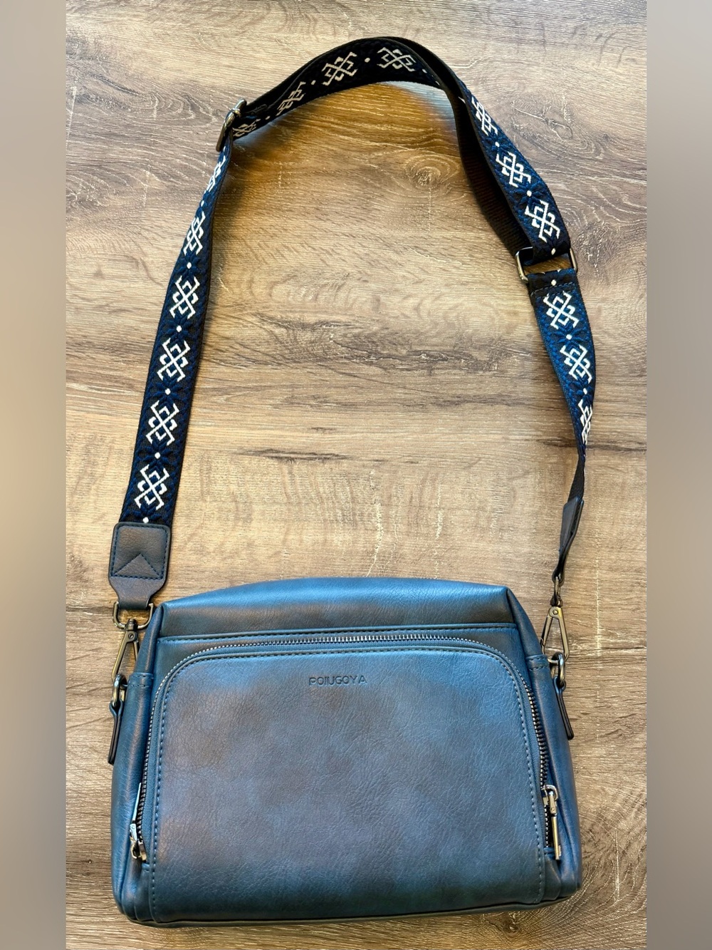 Poiuguya Navy Leather Crossbody Bag with Patterned Strap